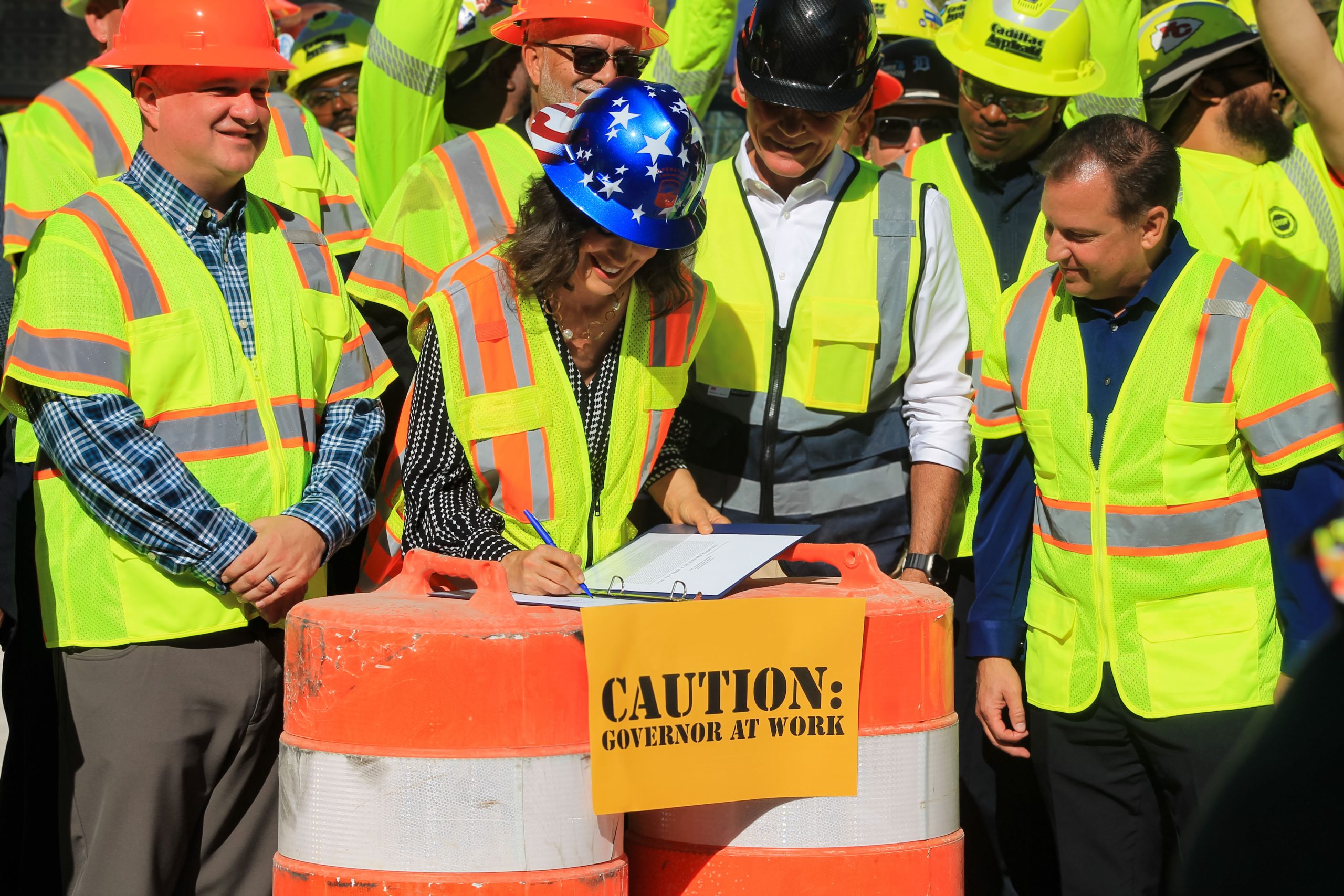 Governor Whitmer, joined by construction workers and local leaders, signs road funding bills into law. 