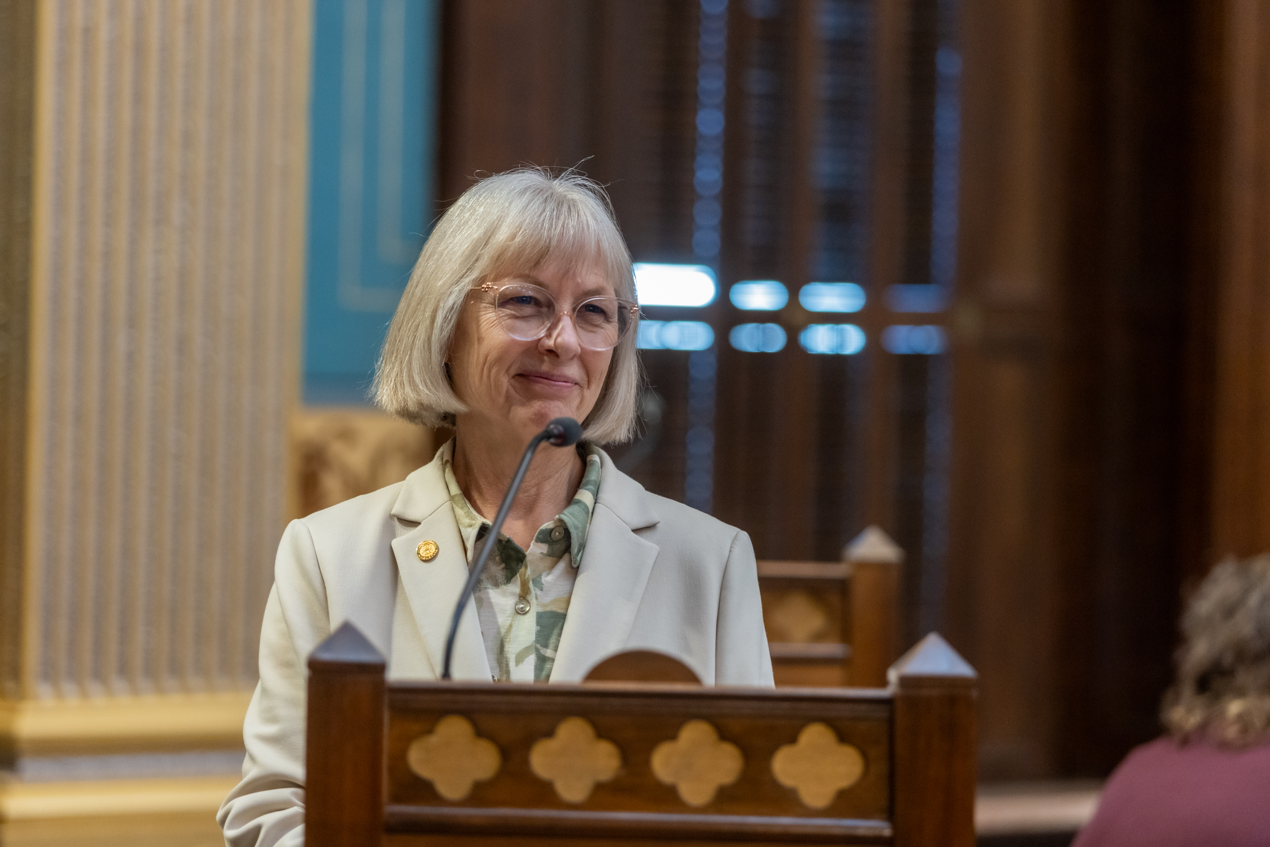 Senator Bayer at the Senate Podium smiling
