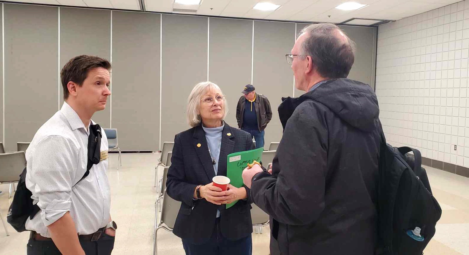 Senator Bayer having a conversation with two constituents