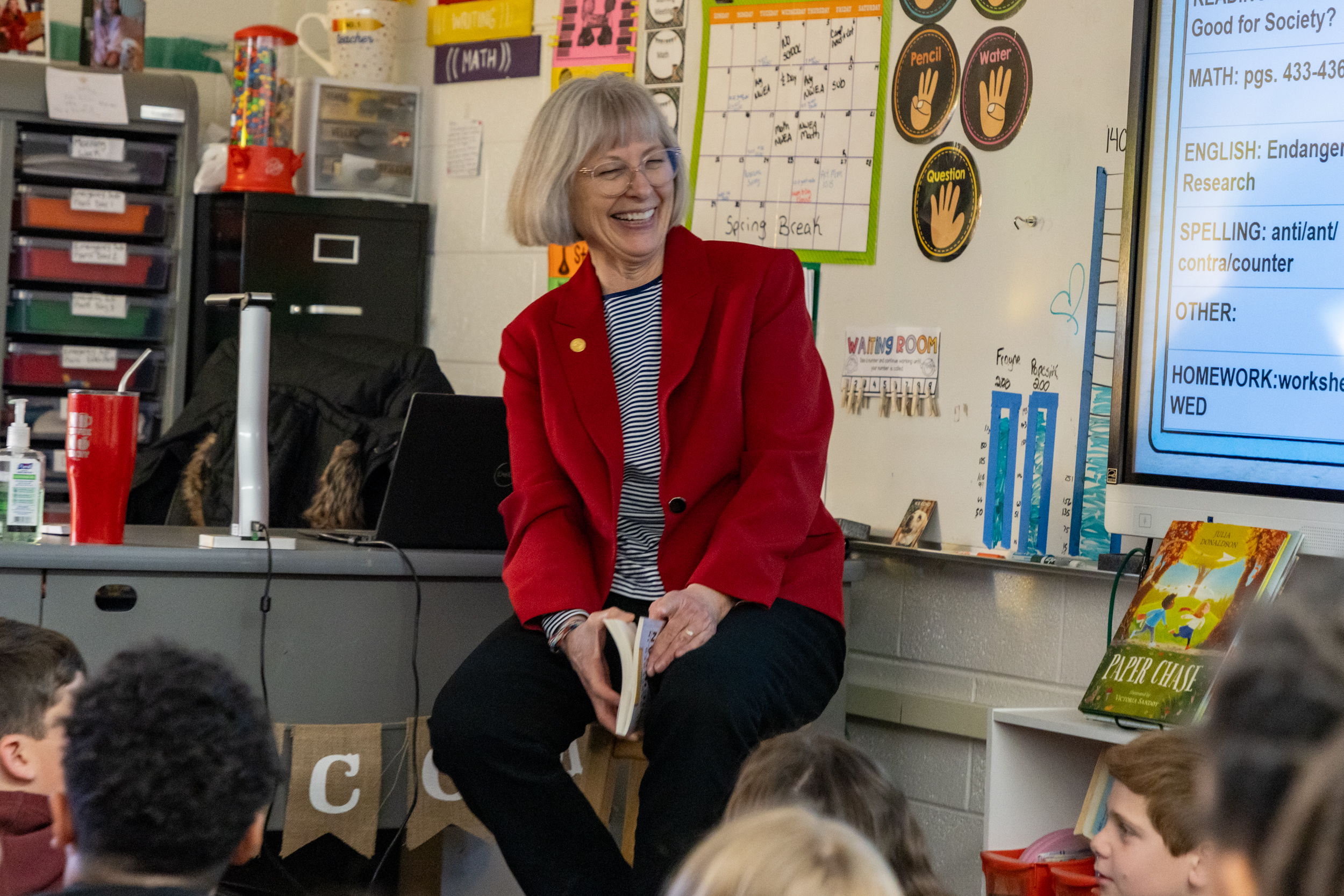 Sen Bayer sitting in front of a class speaking with children at  

Celebrating Reading Month at Isbister Elementary School in Plymouth. The children are seated on the floor and Sen Bayer is smiling