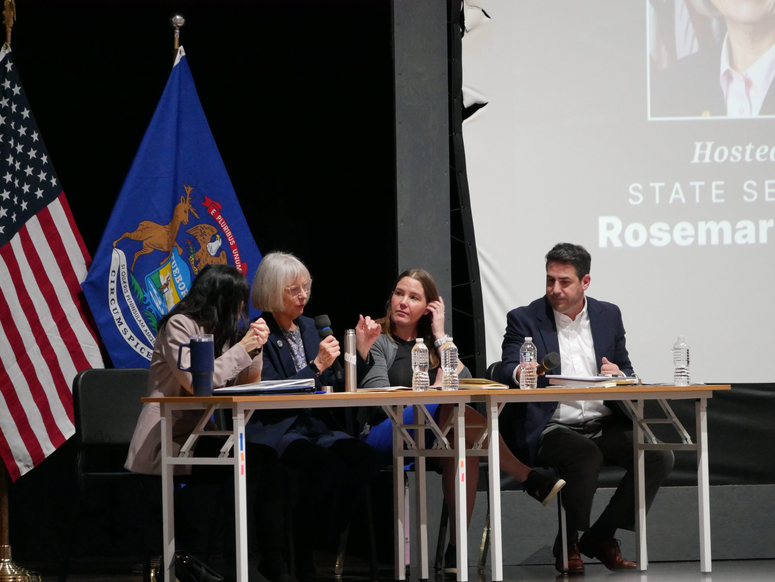 Sen Bayer and panelists sitting at a table at the Data Center Town Hall event