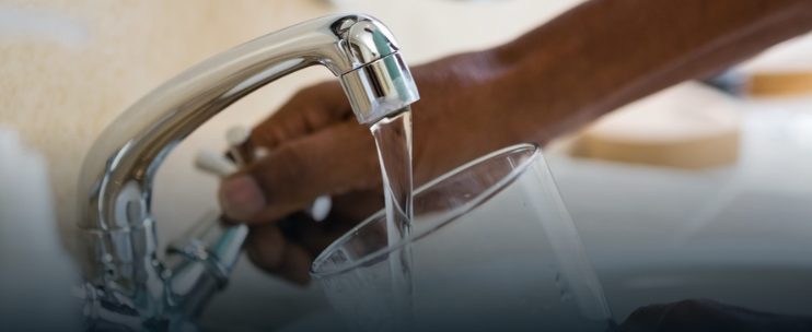 kitchen sink filling a glass of water from faucet