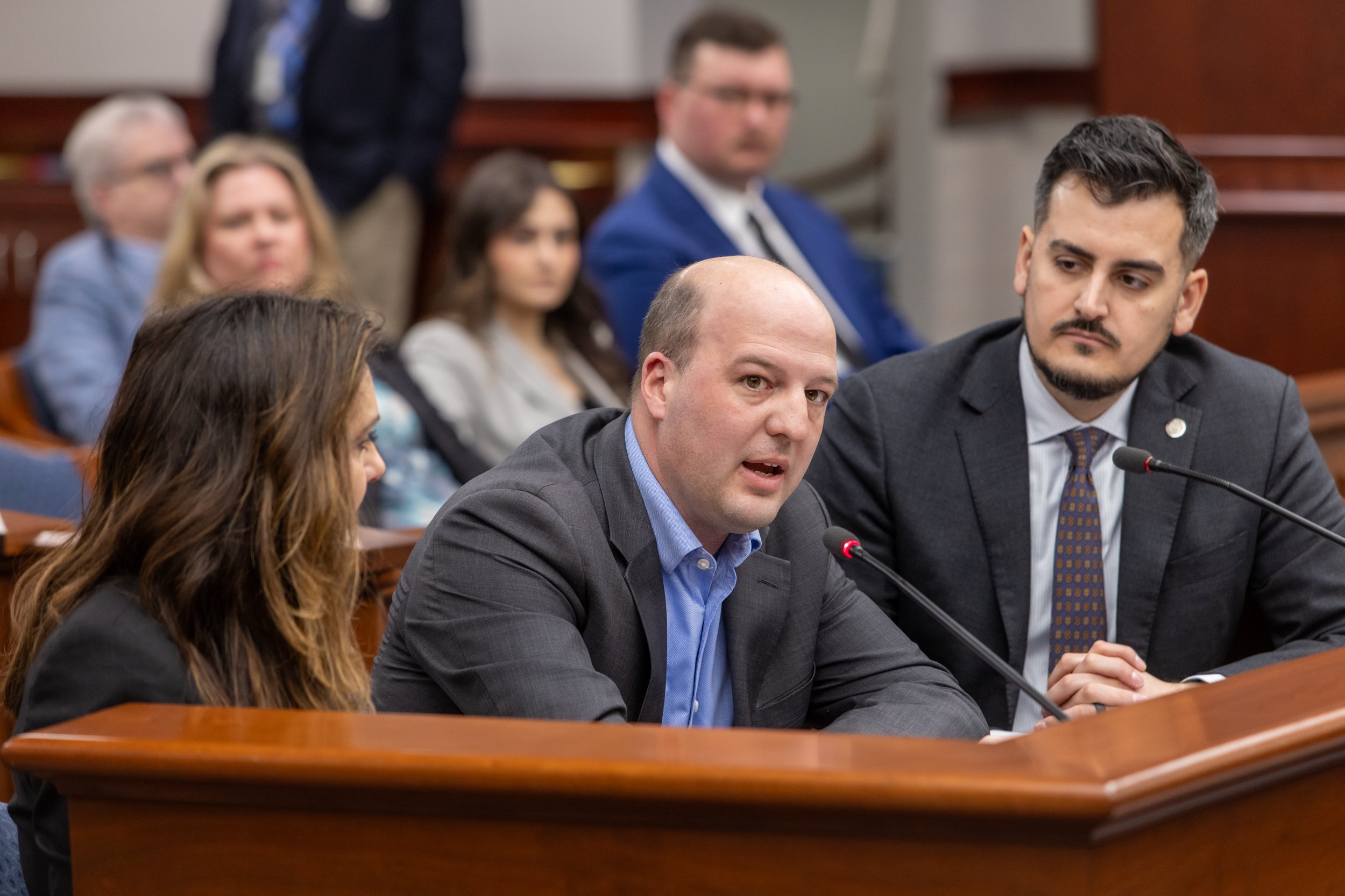 Senator Hertel speaking with Senator Camilleri and Polehanki