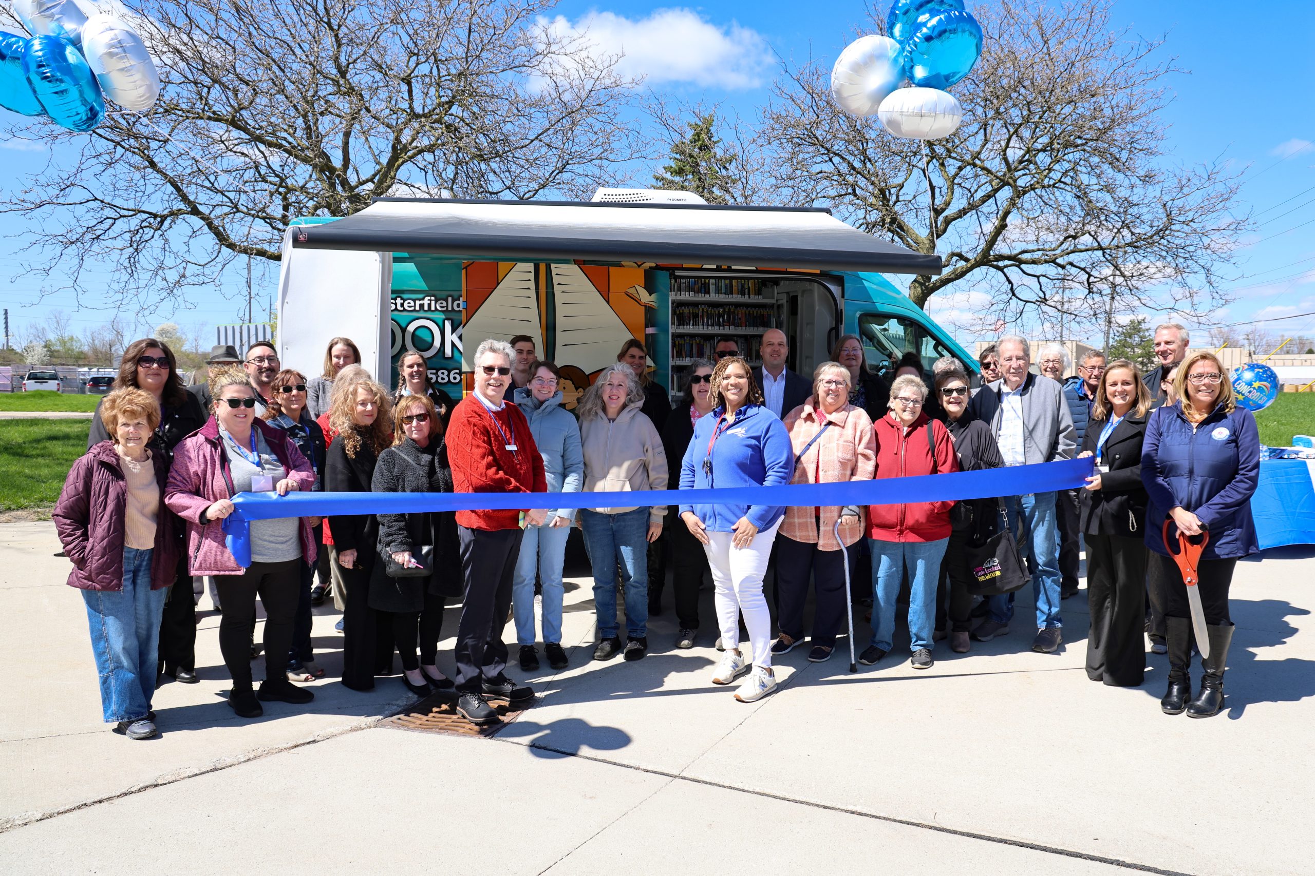 Sen Hertel and a large group of people at the ribbon cutting for the official launch of the Chesterfield Library’s new bookmobile