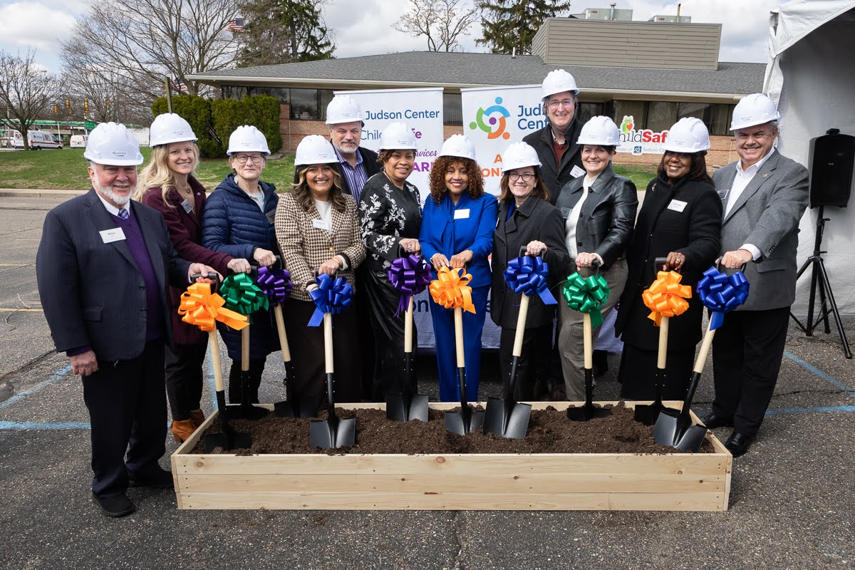 Judson Center Renovation Groundbreaking. Local officials with shovels in a box of dirt and hardhats posing for a photo