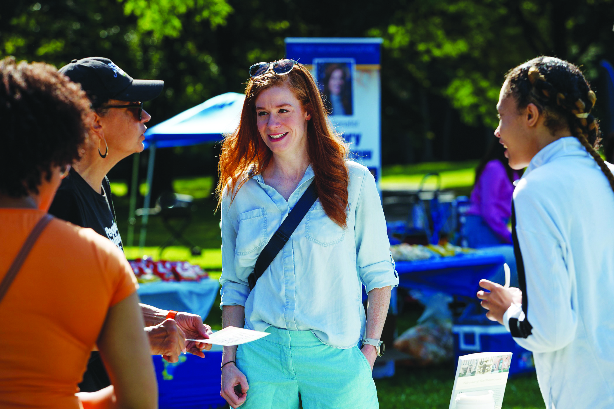Sen McMorrow speaking with constituents at an outdoor event