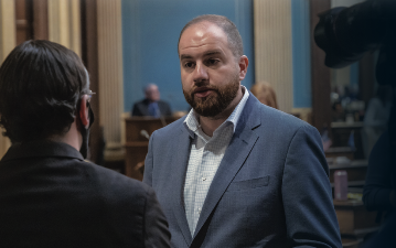 Senator Moss speaking to a reporter on the senate floor