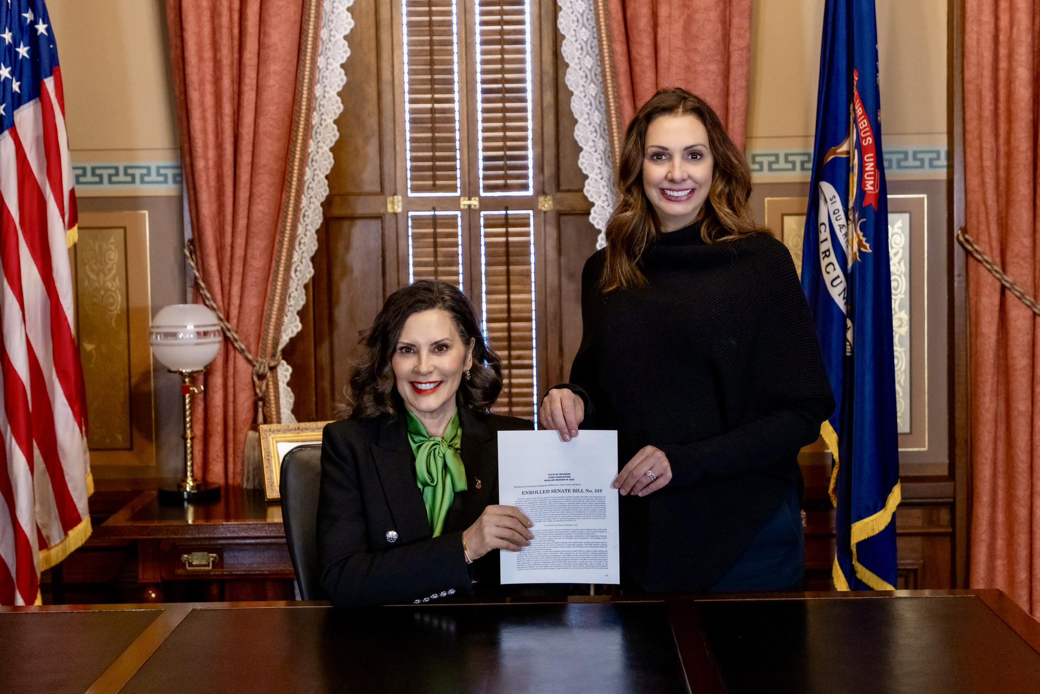 Senator Polehanki and Governor Whitmer holding the signed bill for Standardized testing
