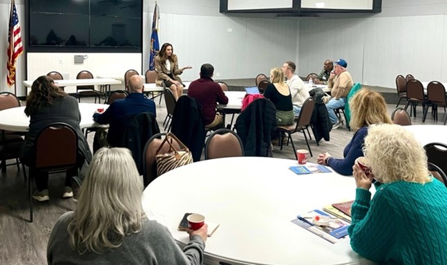 Sen Polehanki speaking with a room filled with constituents