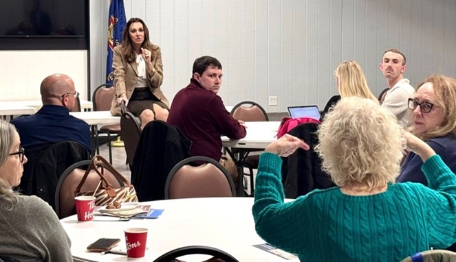 Sen Polehanki speaking with a room filled with constituents