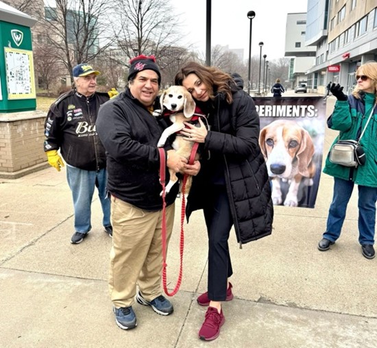 Sen Polehanki standing next to a man and hugging his dog