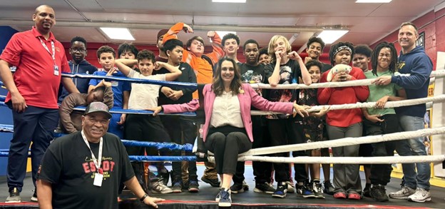 Sen Polehanki joined by kids and coaches in a boxing ring