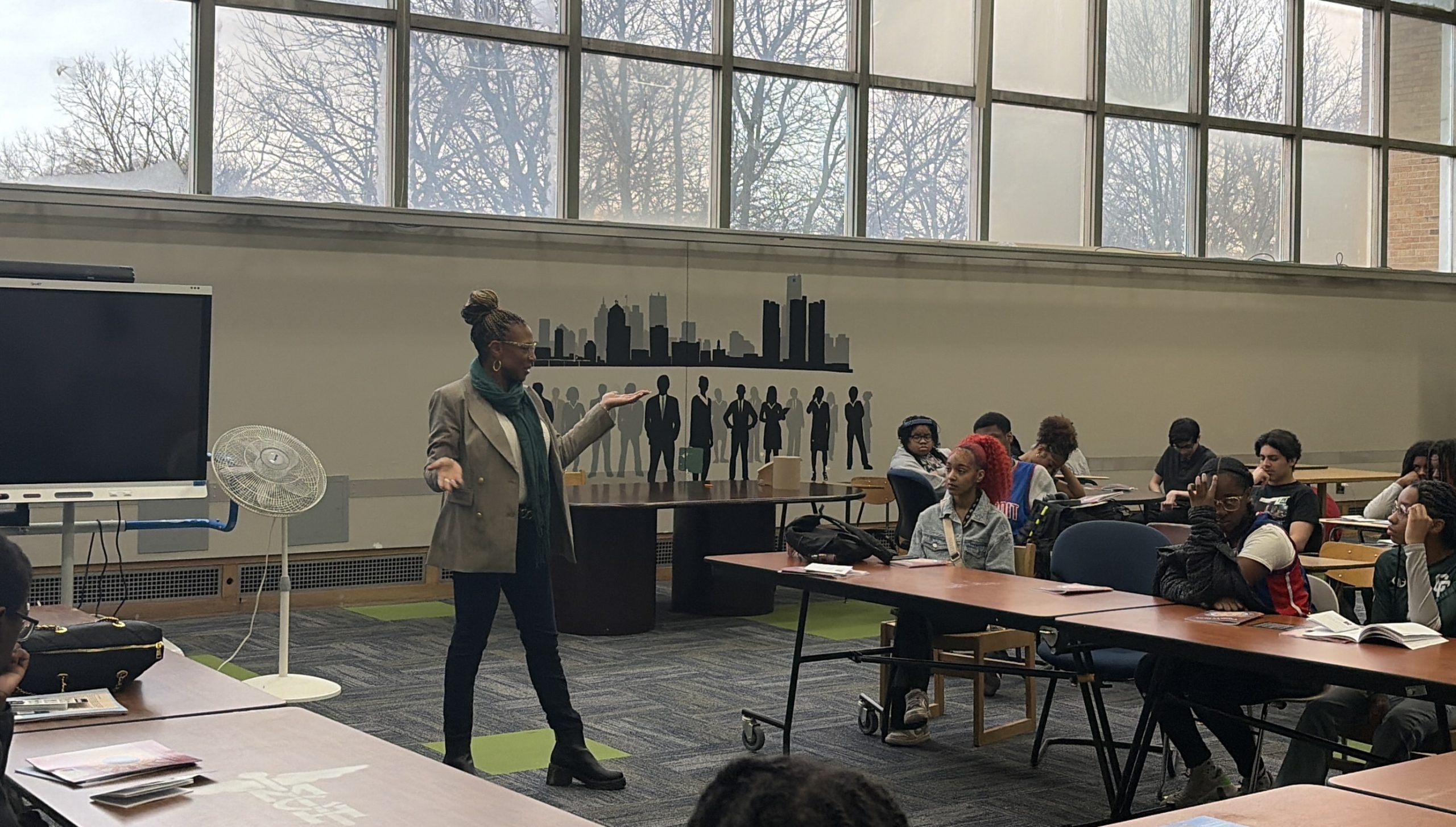 Sen Santana speaking in front of a classroom of children