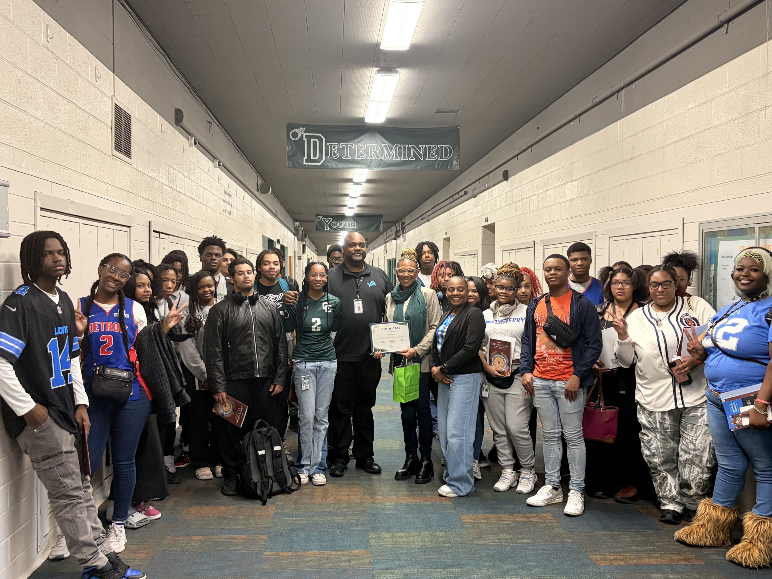Sen Santana posing with a class of highschoolers in a highschool hallway