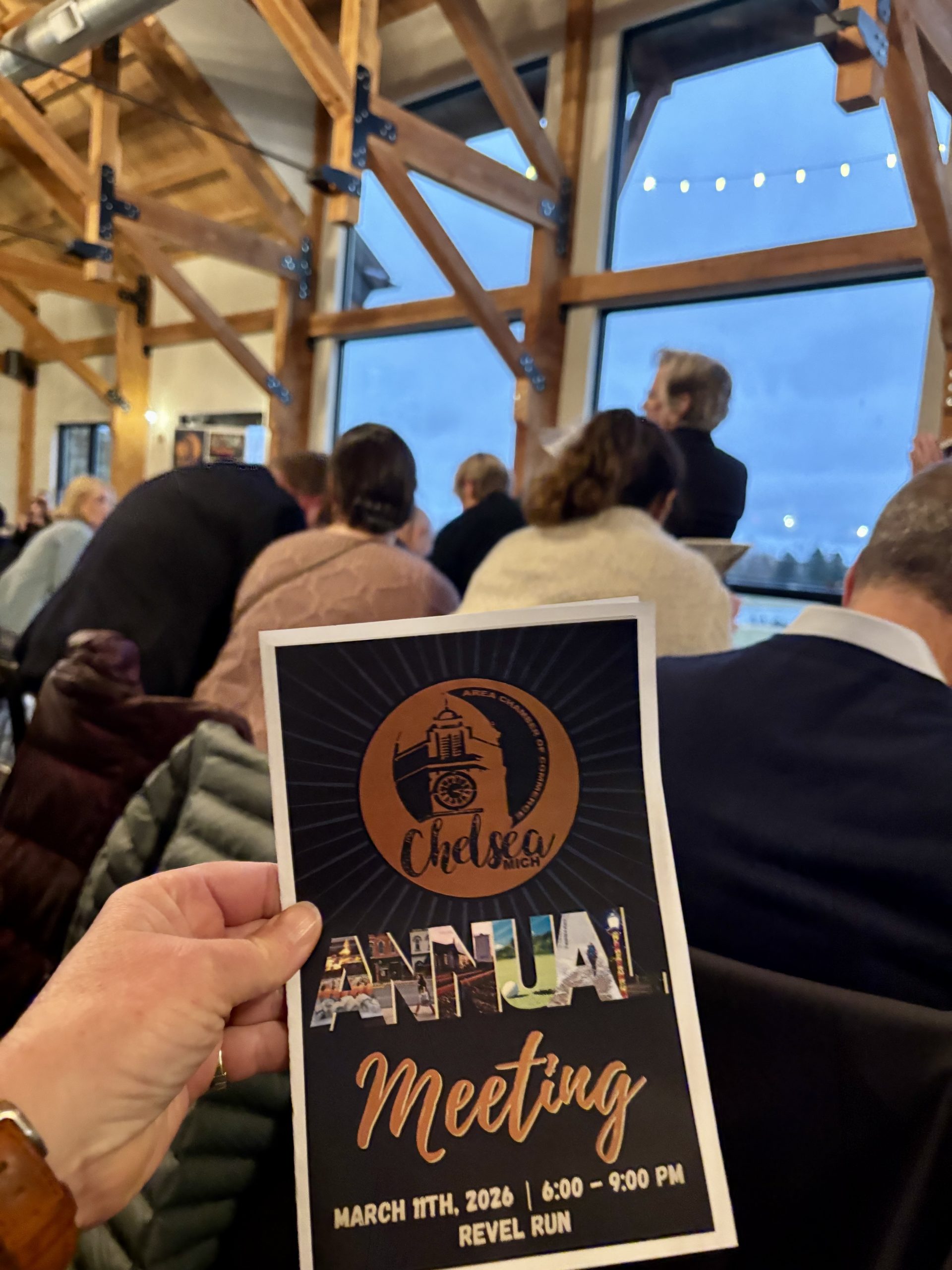 the program from the Chelsea Annual Meeting in front of the crowd of attendees