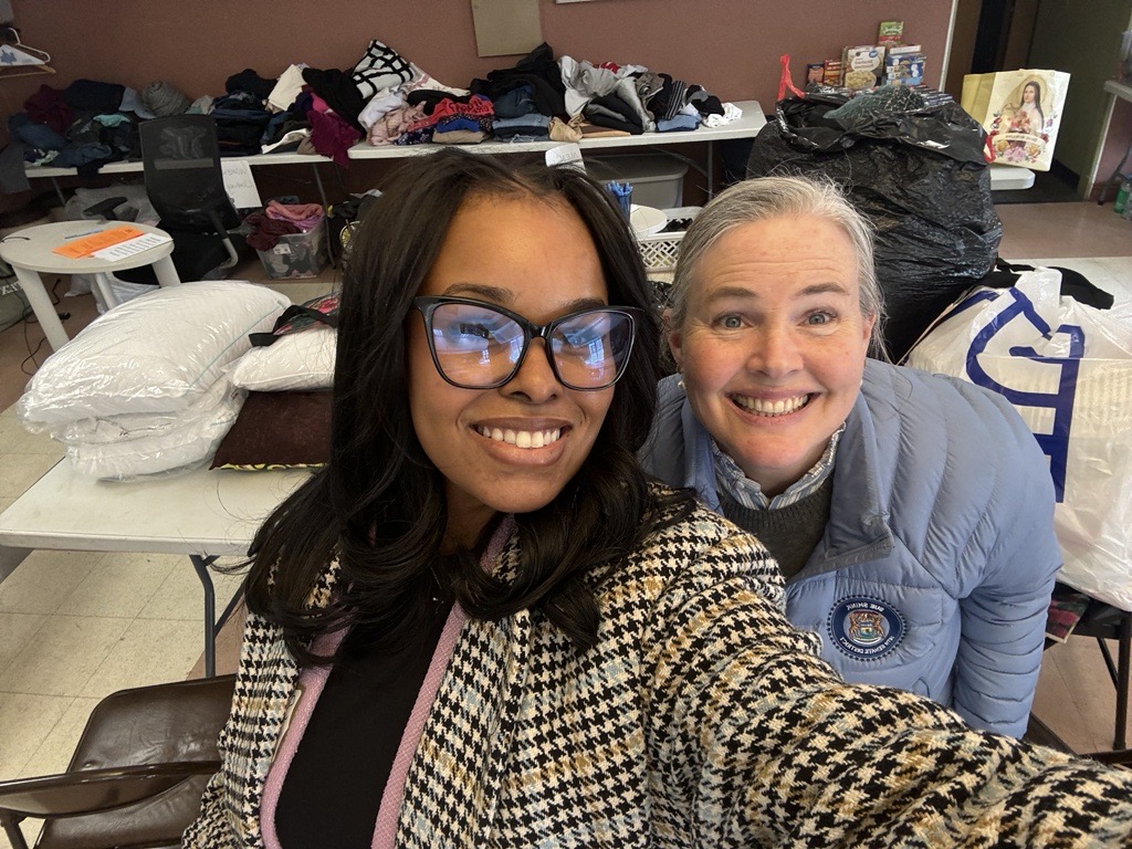 Senator Sue Shink smiling with a volunteer helping with the Reed Manor fire