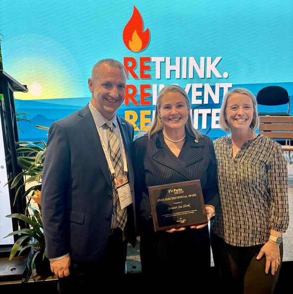 Senator Shink recieving Elected Official Award for demonstrating exceptional leadership and support for parks, recreation, and conservation. She stands beside two people awarding her