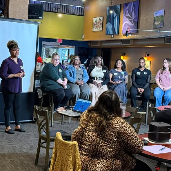 Team Shink attending a panel disccusion State of Infant and Maternal Health in Jackson. Six women are sitting at the front participating in the panel