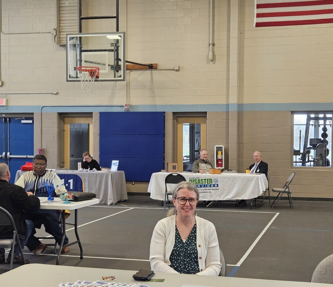 Team Shink at the Resource Fair for the Reed Manor Fire Response. A woman is smiling at a table